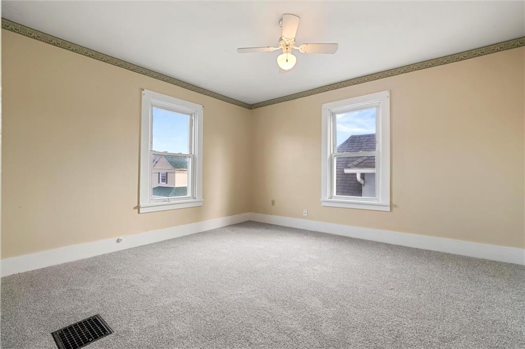 325 Walnut Street Vandergrift, PA 15690 - Photo 17 of 29 an empty room with windows and fan