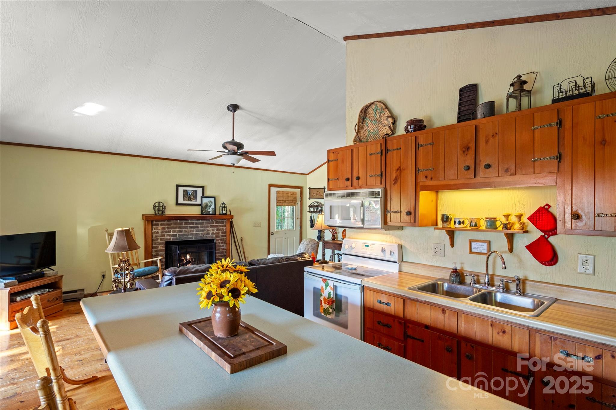 31 Piney Rdg Lane, Unit 27 Saluda, NC 28773 - Photo 12 of 36 a living room with furniture gym equipment and a fireplace