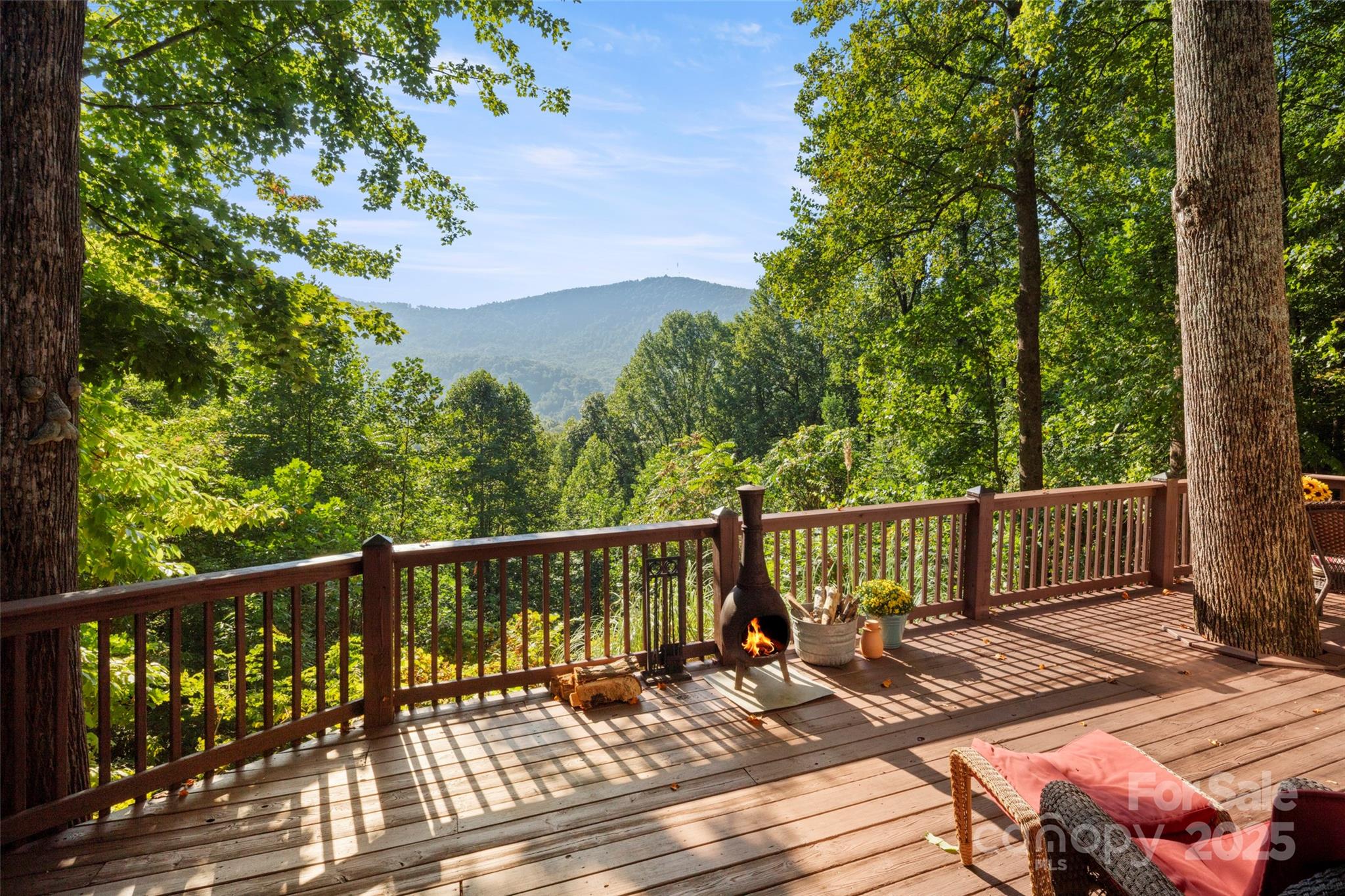 31 Piney Rdg Lane, Unit 27 Saluda, NC 28773 - Photo 16 of 36 a view of a deck with two chair and wooden floor