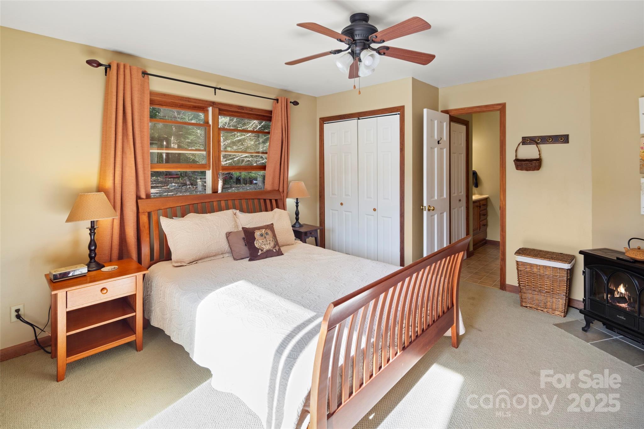 31 Piney Rdg Lane, Unit 27 Saluda, NC 28773 - Photo 17 of 36 a bedroom with a bed a ceiling fan and a large window