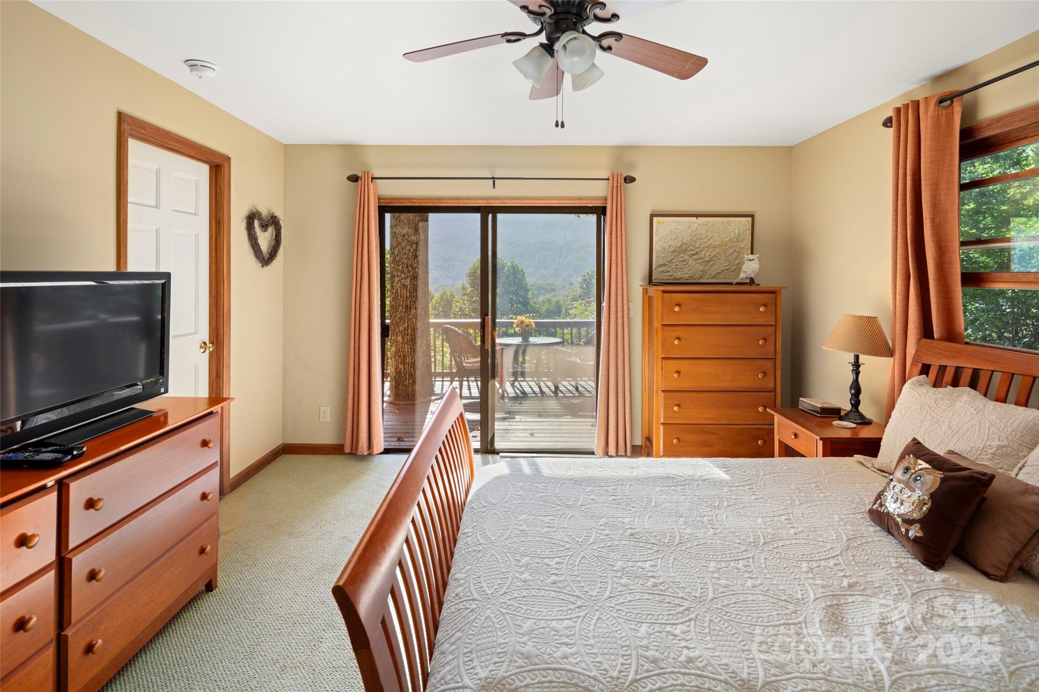 31 Piney Rdg Lane, Unit 27 Saluda, NC 28773 - Photo 18 of 36 a bedroom with furniture and a flat screen tv