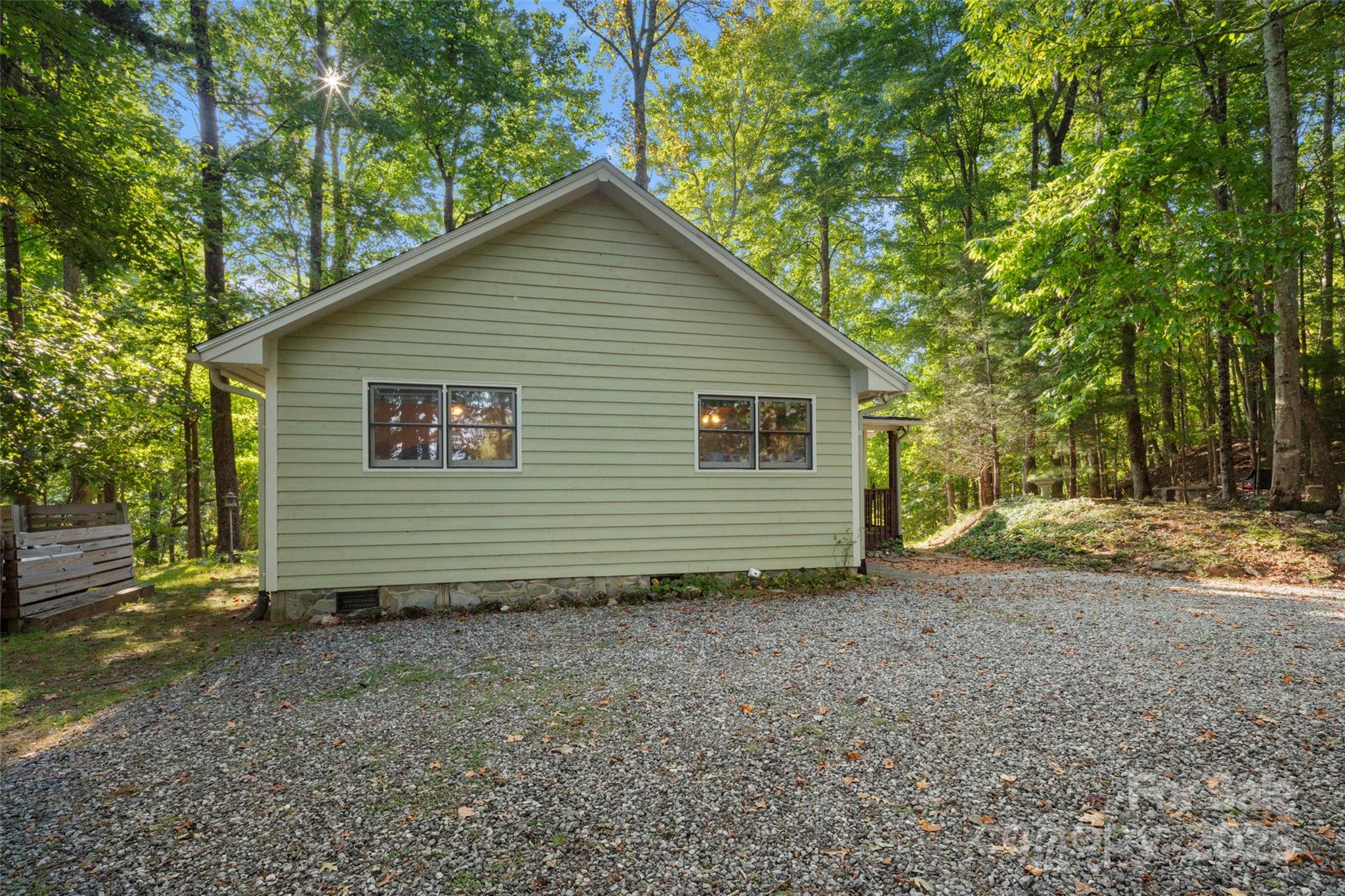 31 Piney Rdg Lane, Unit 27 Saluda, NC 28773 - Photo 28 of 36 a view of a house with a yard and large tree