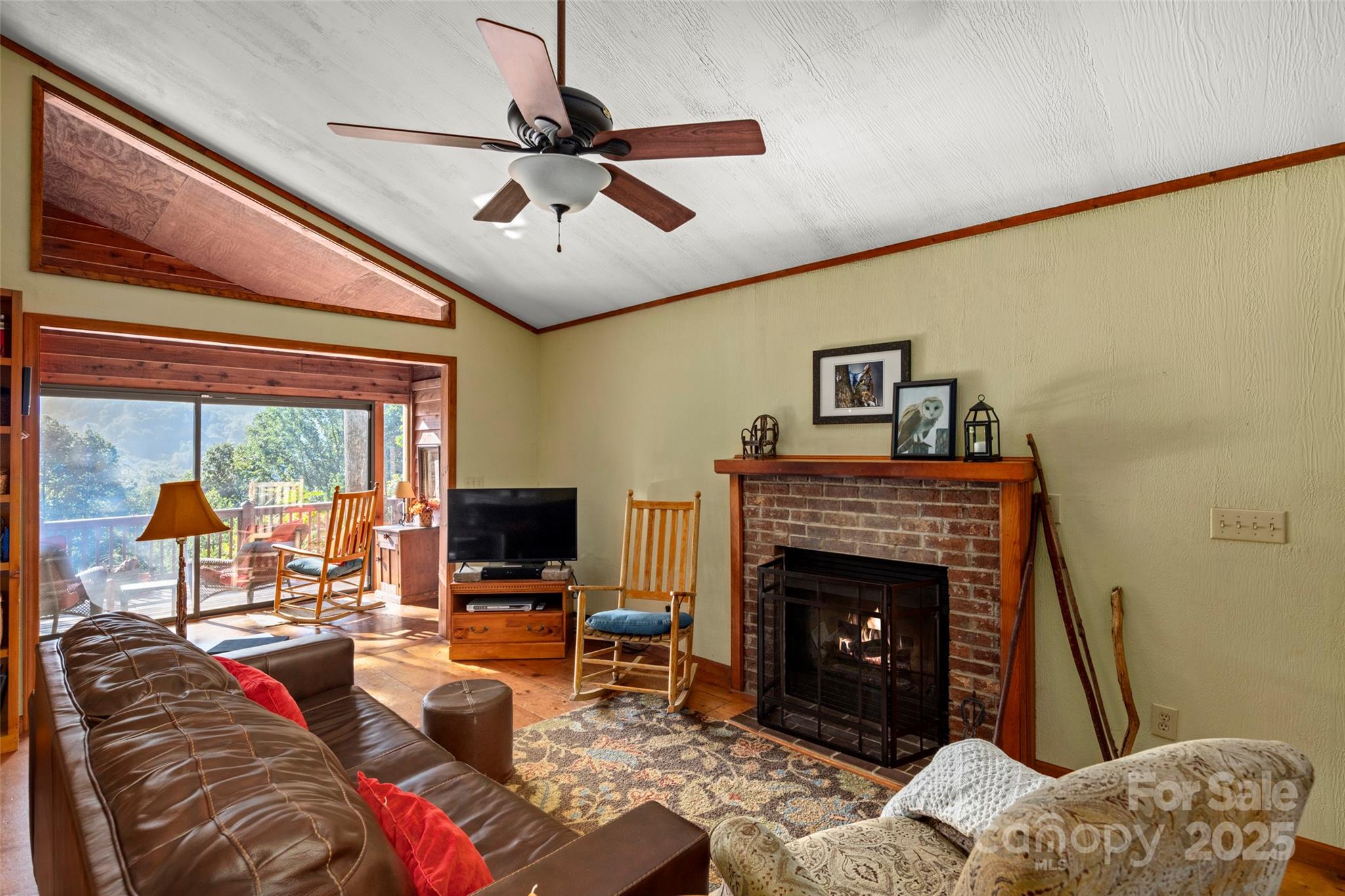 31 Piney Rdg Lane, Unit 27 Saluda, NC 28773 - Photo 9 of 36 a living room with furniture a flat screen tv and a fireplace
