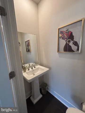 a bathroom with a sink toilet and mirror