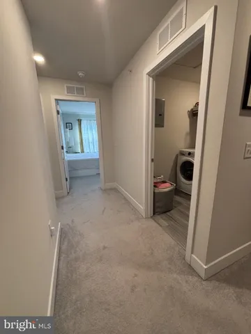 a living room with furniture a flat screen tv and a window