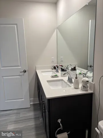 a bathroom with a double vanity sink toilet and shower