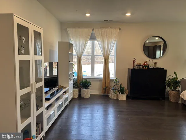 a living room with furniture flat screen tv and a fireplace