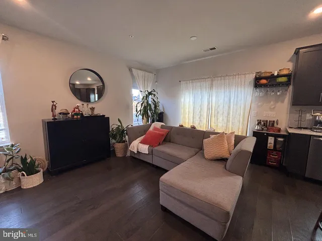 a kitchen with stainless steel appliances granite countertop refrigerator a sink dishwasher a stove top oven a refrigerator and cabinets