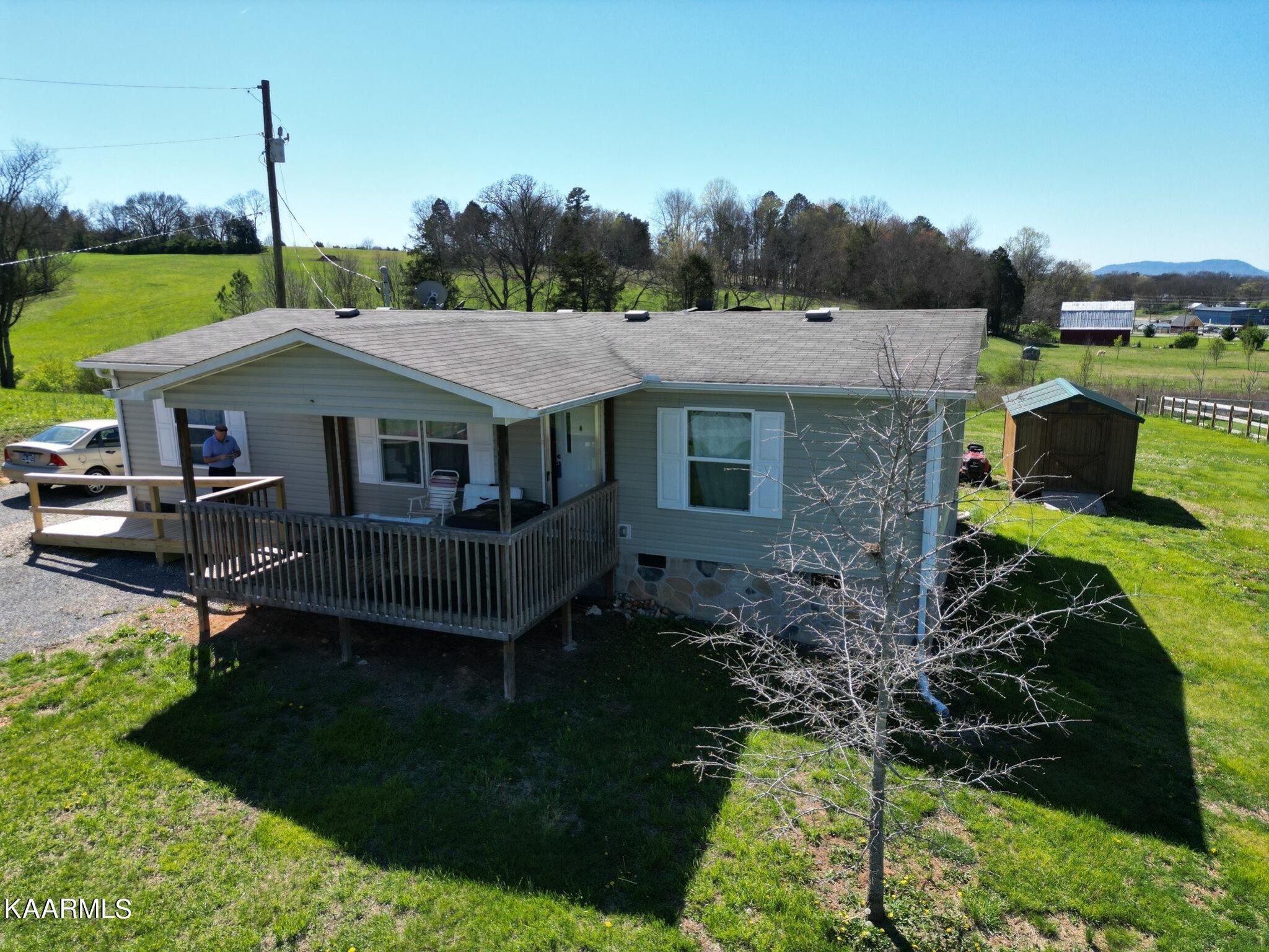 a aerial view of a house with a yard table and chairs