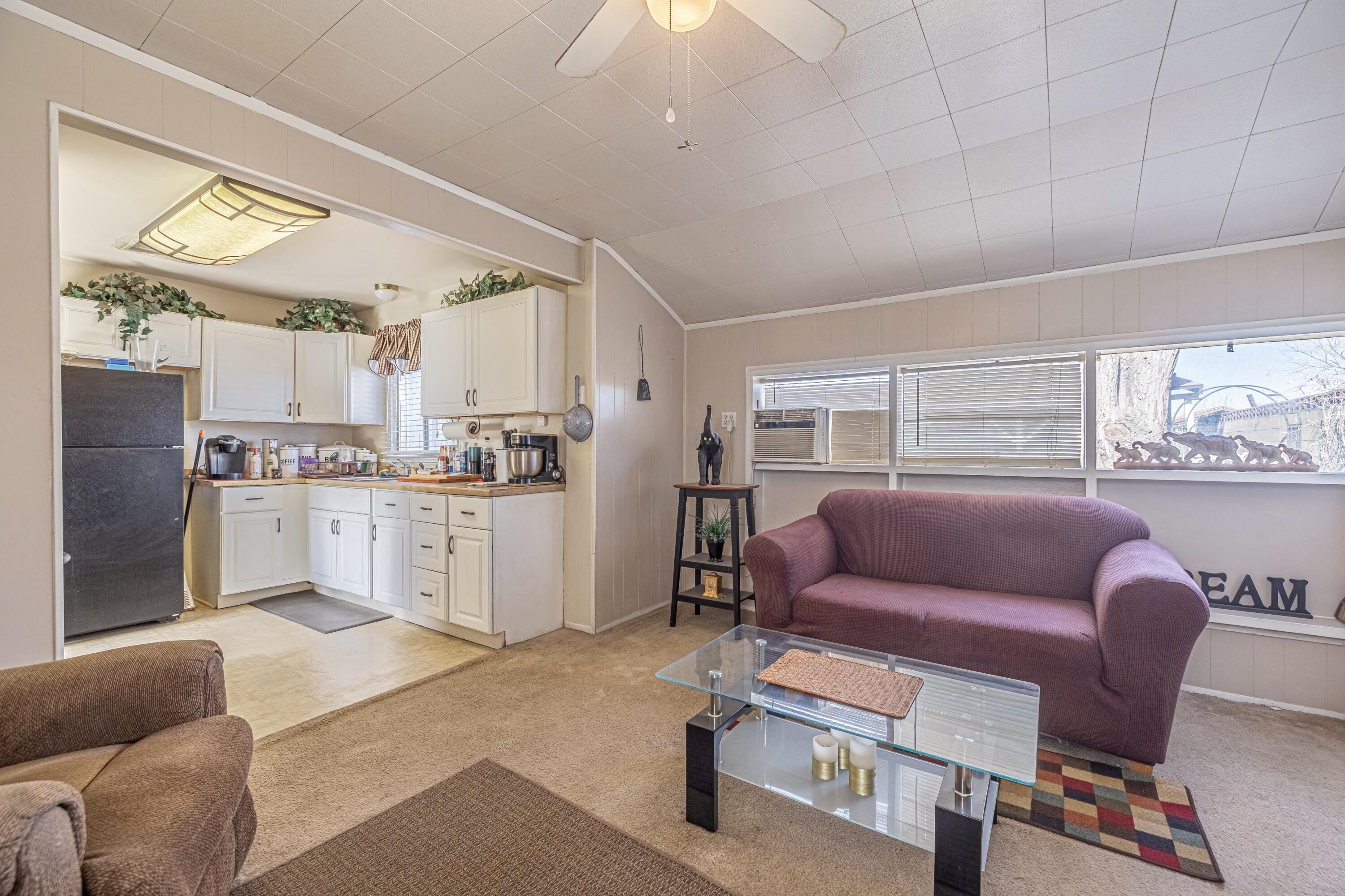 5245 West Ave L4 Lancaster, CA 93536 - Photo 11 of 35 a living room with furniture and a kitchen view