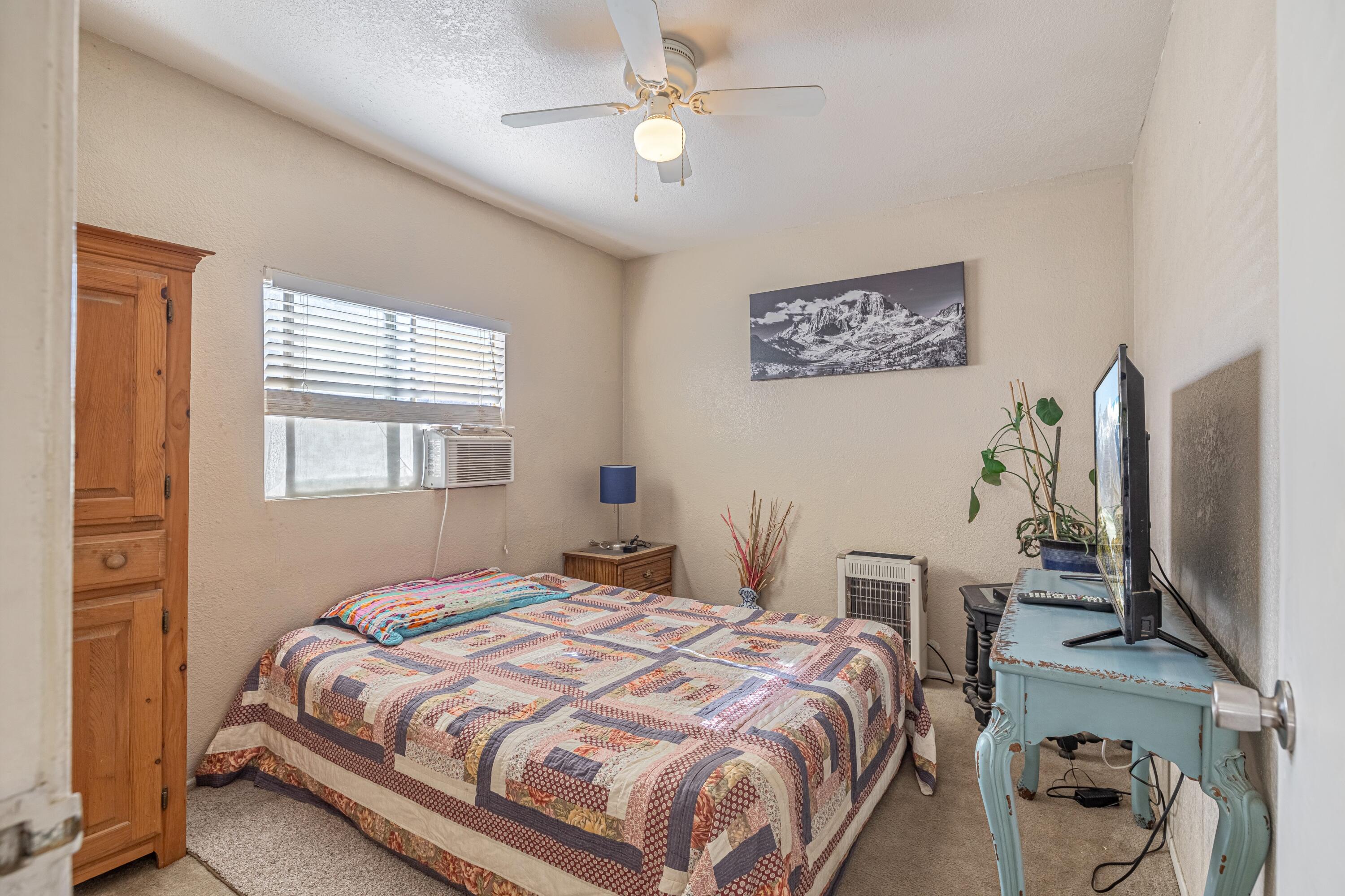 5245 West Ave L4 Lancaster, CA 93536 - Photo 14 of 35 a bedroom with a bed and a flat screen tv