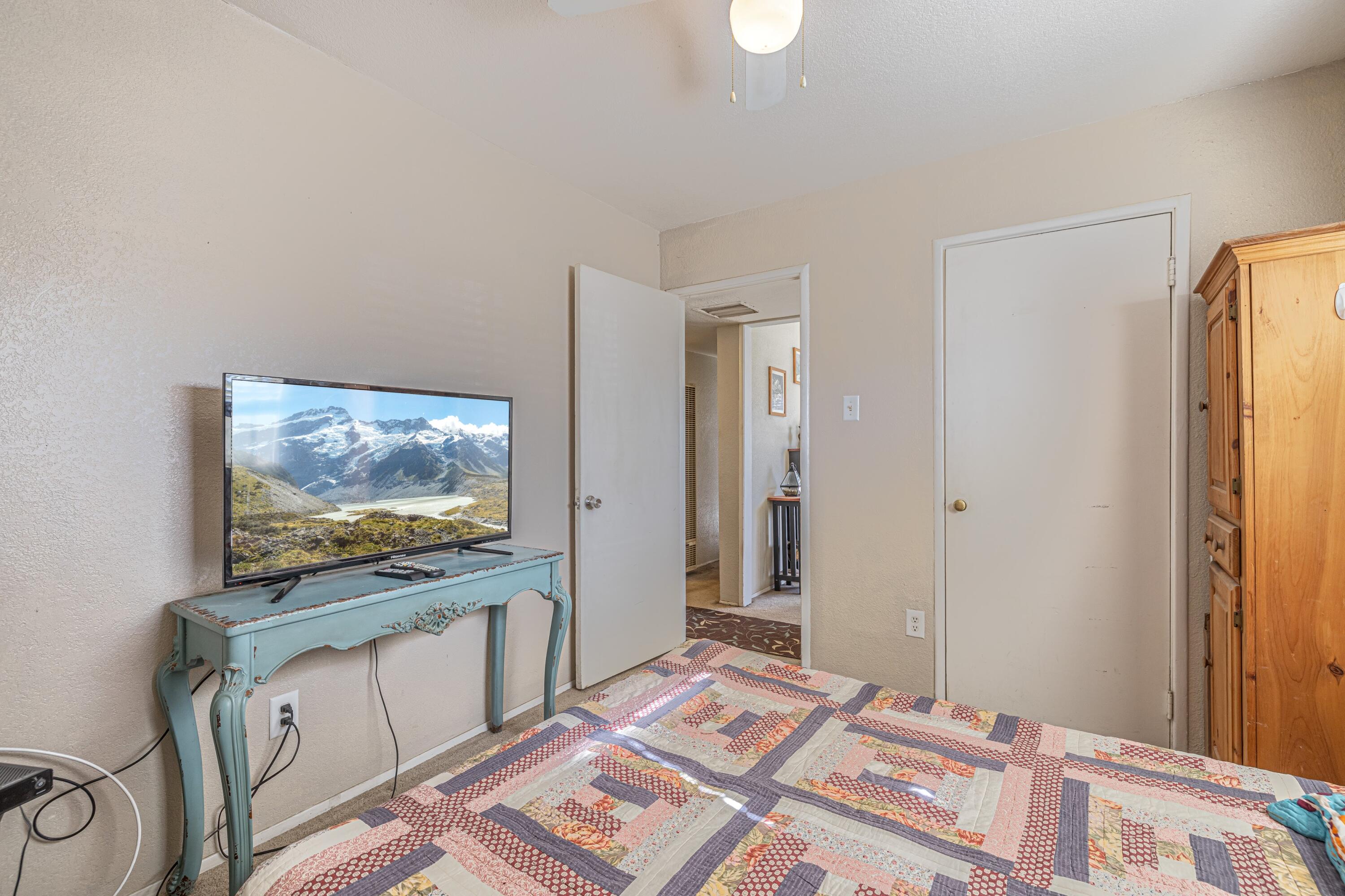 5245 West Ave L4 Lancaster, CA 93536 - Photo 15 of 35 a bedroom with a bed and a flat screen tv