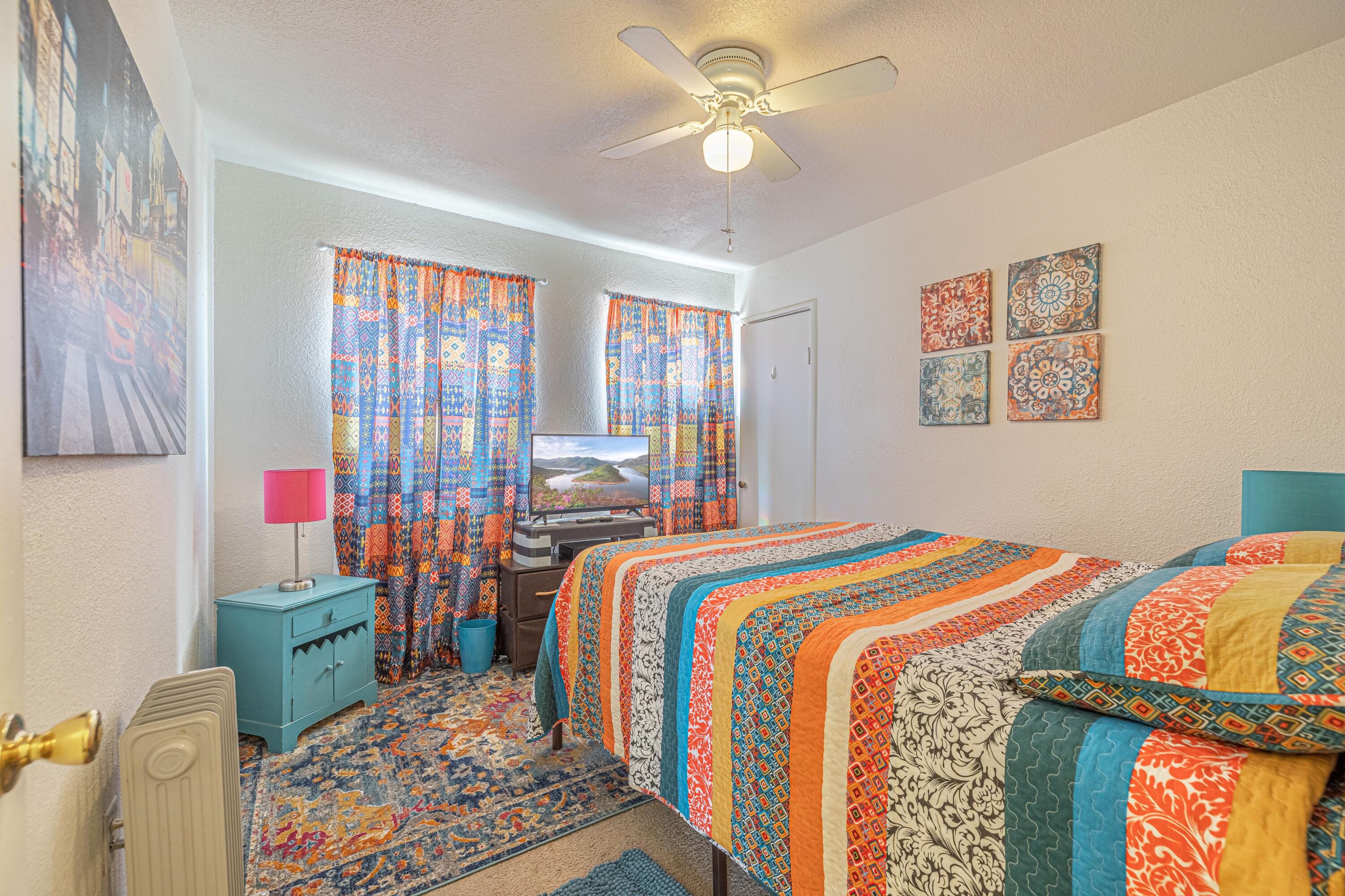 5245 West Ave L4 Lancaster, CA 93536 - Photo 16 of 35 a bedroom with a bed and a chandelier