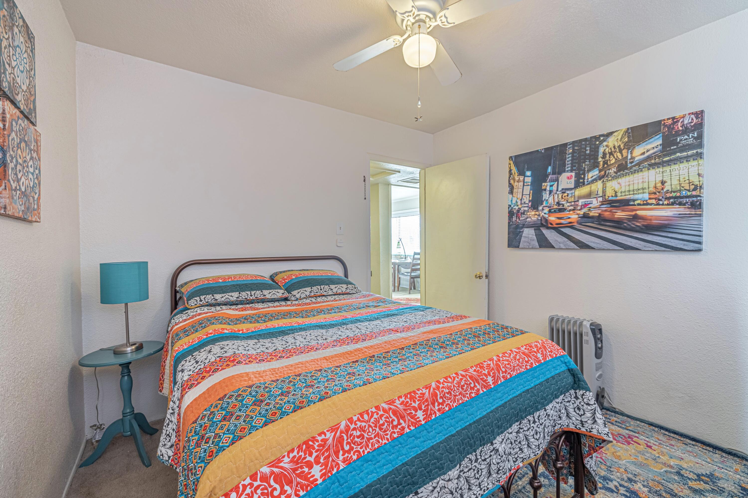 5245 West Ave L4 Lancaster, CA 93536 - Photo 17 of 35 a bedroom with bed and paintings on the wall