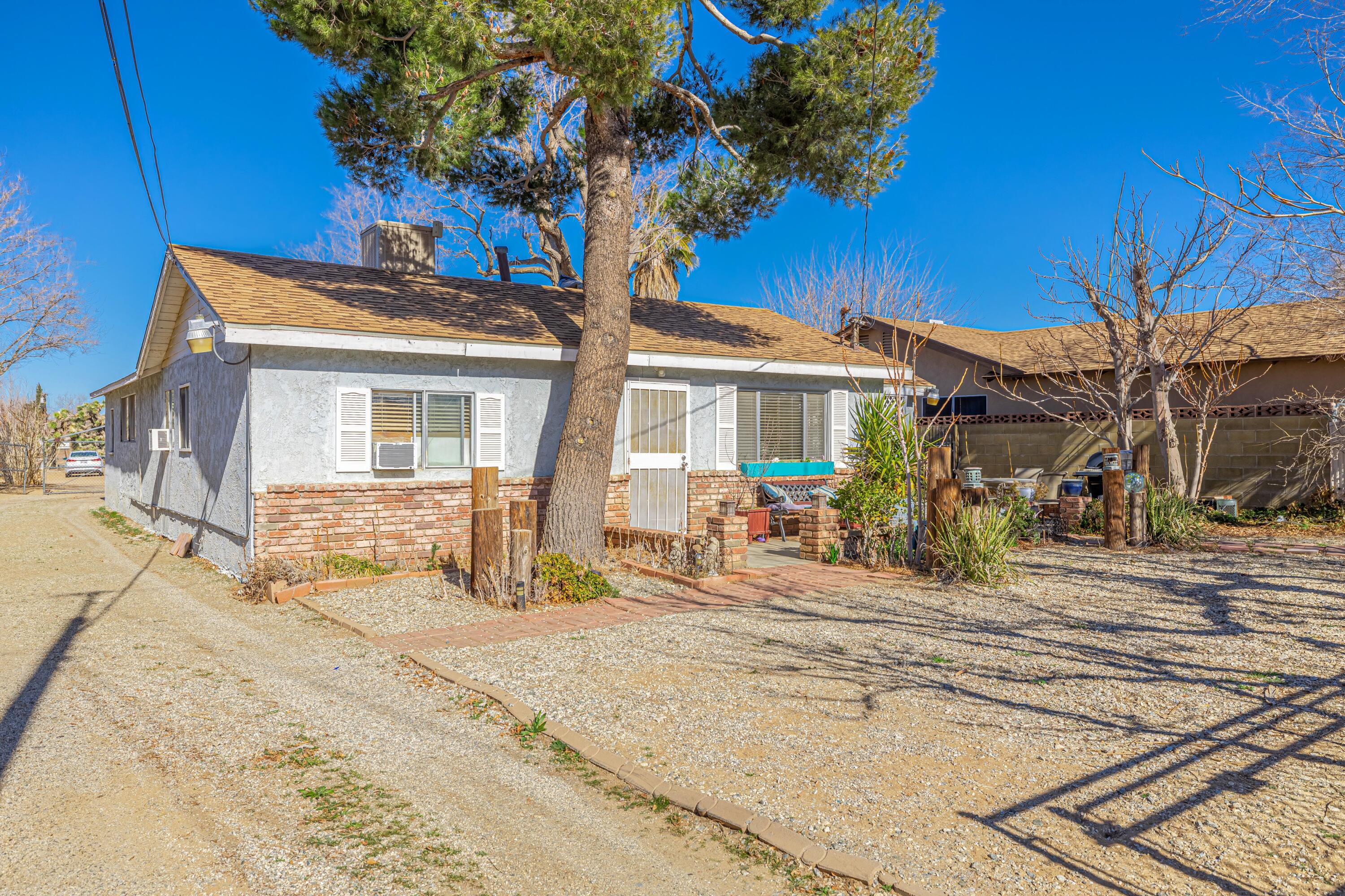 5245 West Ave L4 Lancaster, CA 93536 - Photo 2 of 35 a front view of a house with a tree