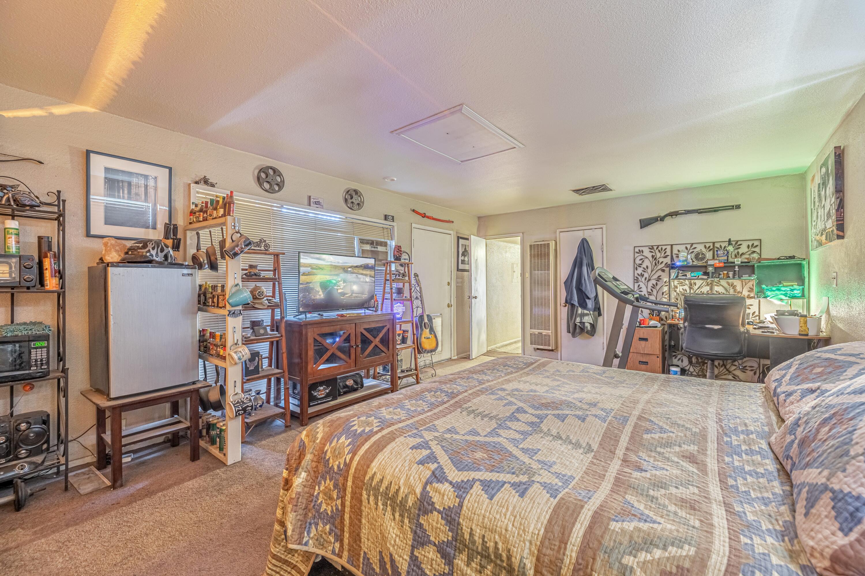 5245 West Ave L4 Lancaster, CA 93536 - Photo 22 of 35 a bedroom with a bed and a chair