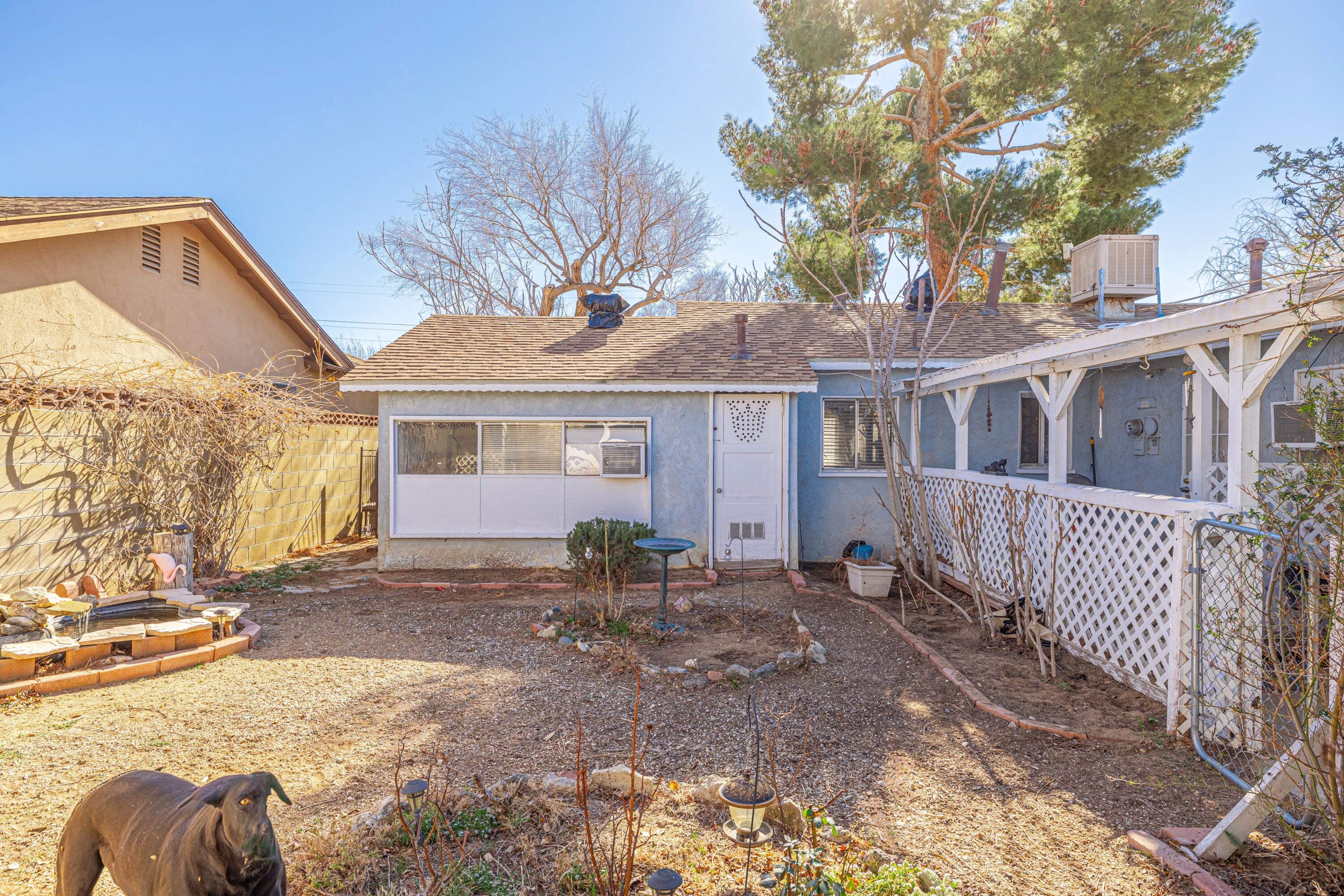 5245 West Ave L4 Lancaster, CA 93536 - Photo 26 of 35 a front view of a house with a yard