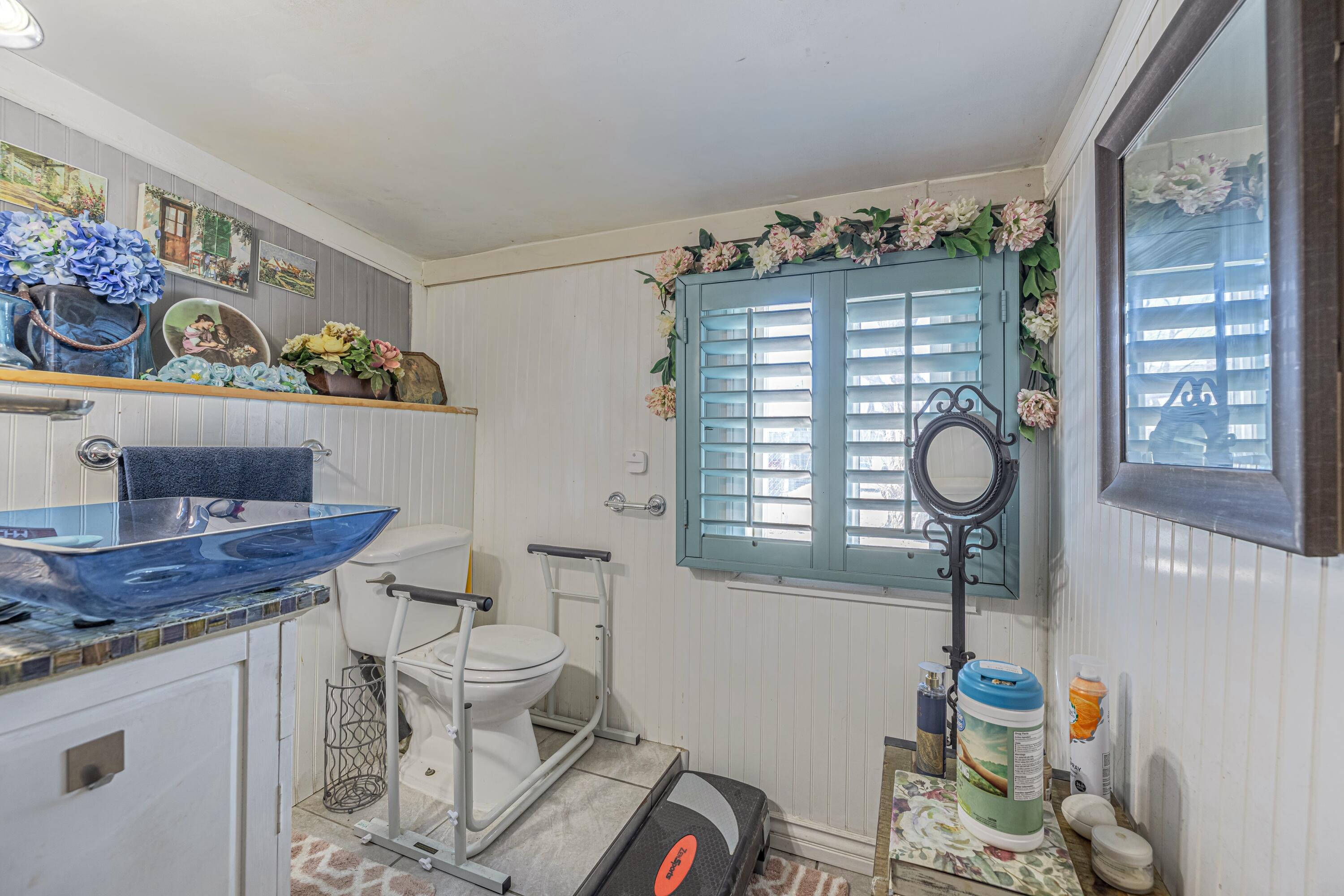 5245 West Ave L4 Lancaster, CA 93536 - Photo 28 of 35 a bathroom with a toilet sink and mirror