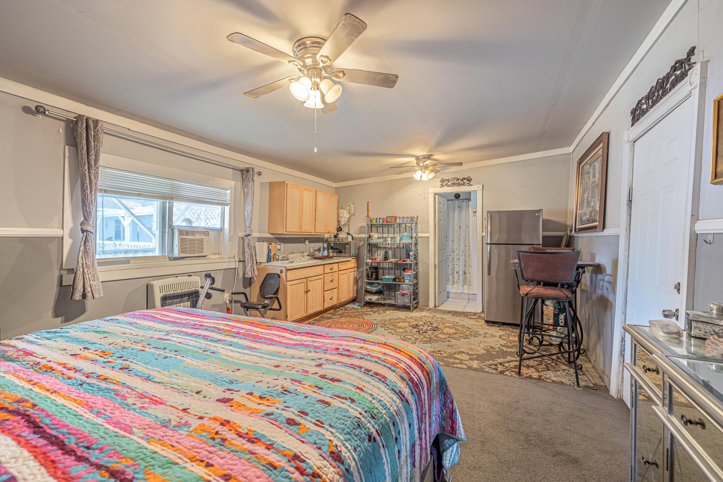 5245 West Ave L4 Lancaster, CA 93536 - Photo 30 of 35 a bedroom with a bed large window and flat screen tv