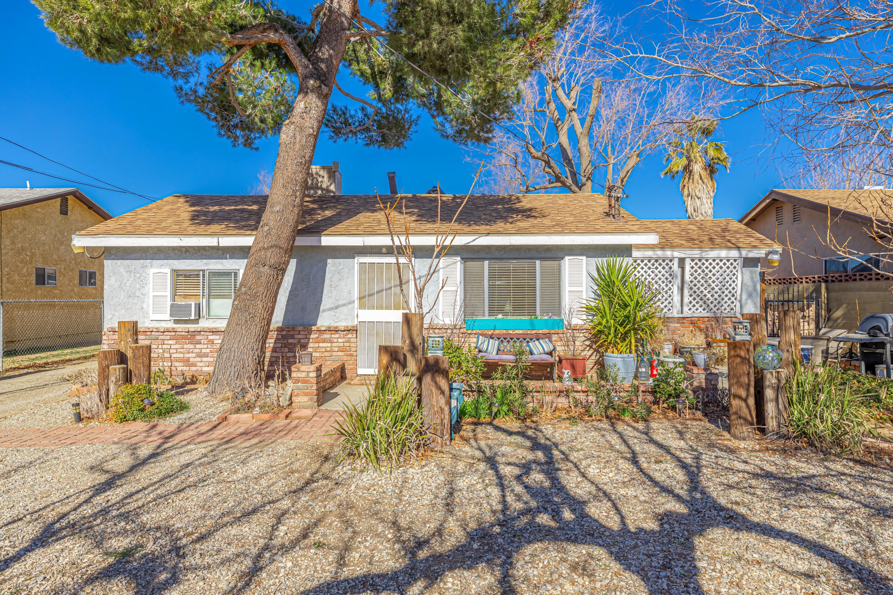 5245 West Ave L4 Lancaster, CA 93536 - Photo 3 of 35 a front view of a house with a tree