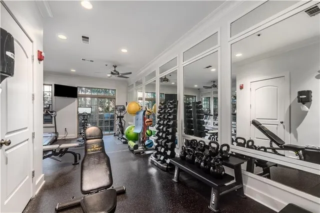 a room with lots of potted plants kitchen view and a refrigerator