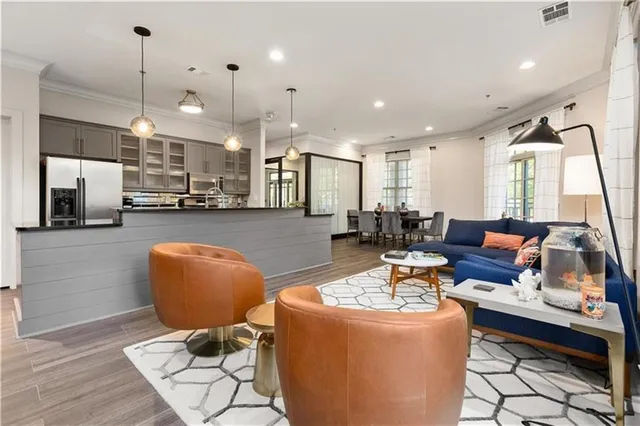 a living room with fireplace furniture and a large window