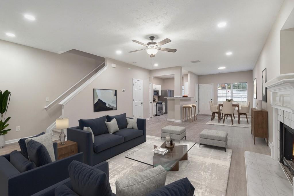 a living room with furniture kitchen view and a chandelier