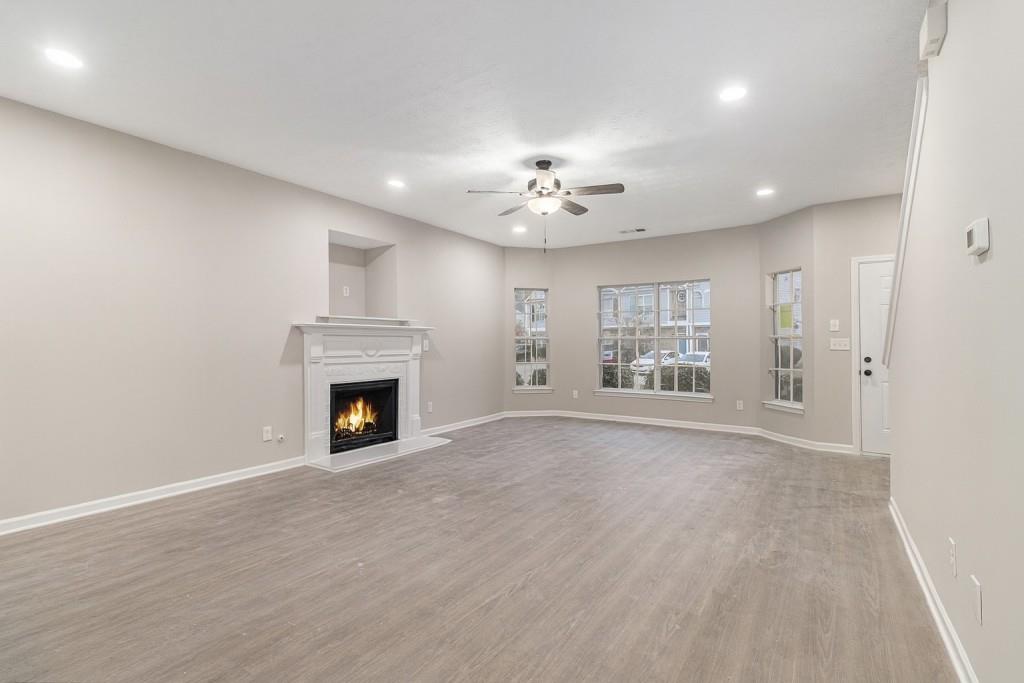2563 Walden Lake Drive Decatur, GA 30035 - Photo 11 of 27 a view of a livingroom with a fireplace a chandelier and closet