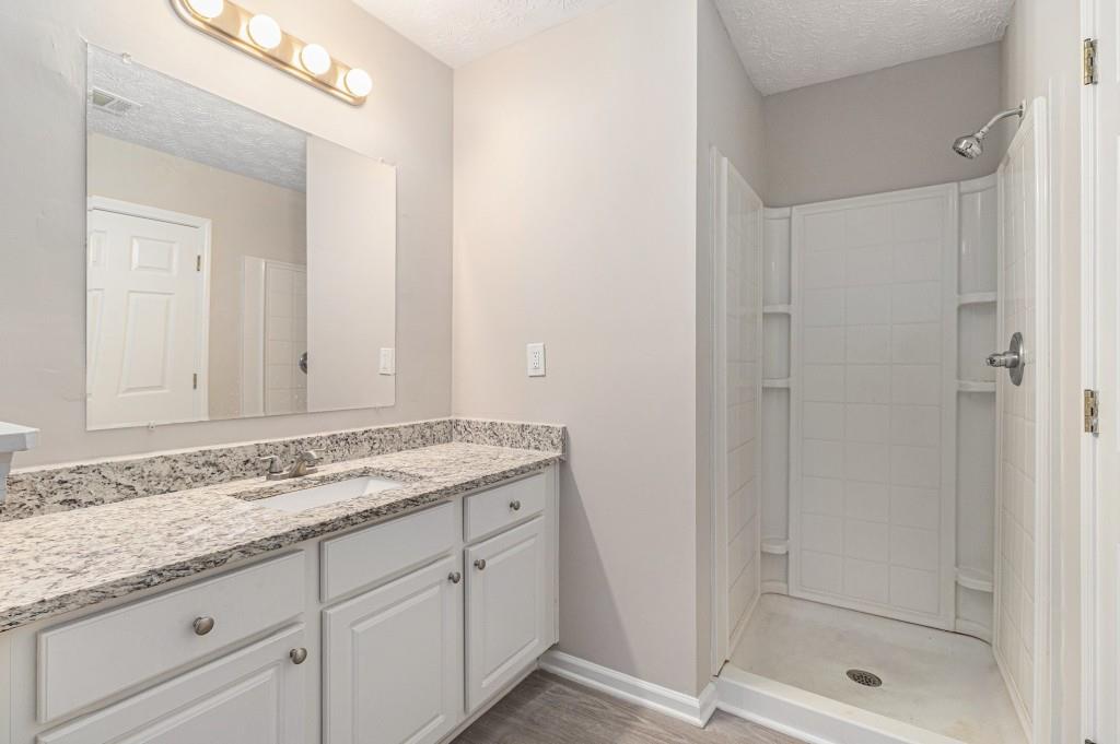 2563 Walden Lake Drive Decatur, GA 30035 - Photo 18 of 27 a bathroom with a granite countertop sink and mirror