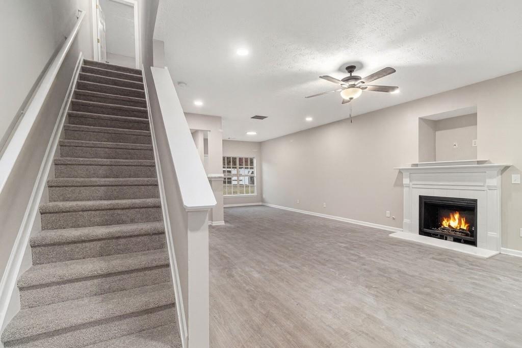 2563 Walden Lake Drive Decatur, GA 30035 - Photo 9 of 27 a view of a livingroom with a fireplace stairs and a window