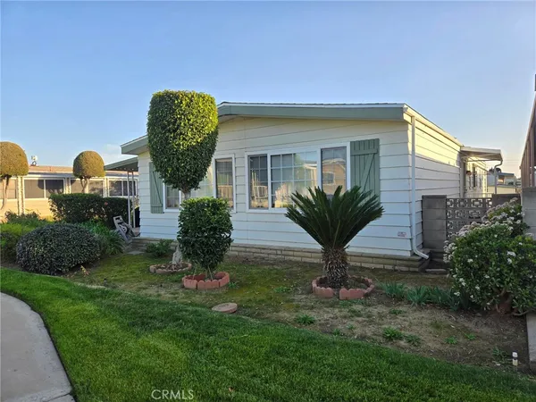 a view of a house with a backyard and a garden