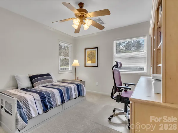 a bedroom with a bed and a desk