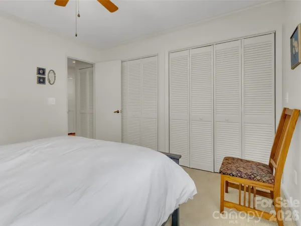 a bedroom with a bed and a chair