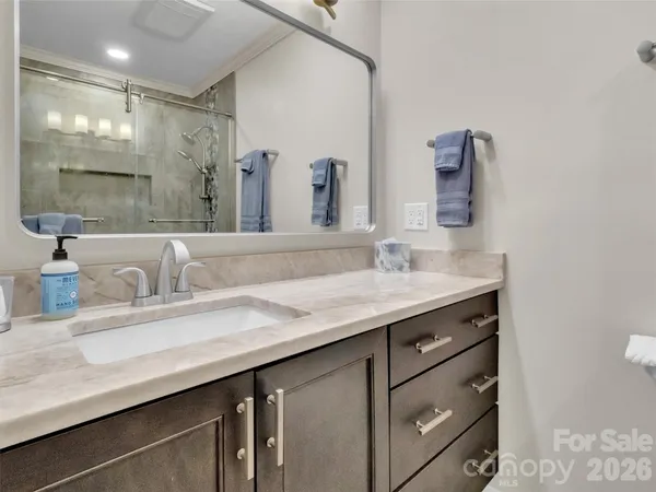 a bathroom with a granite countertop sink a large mirror and a
