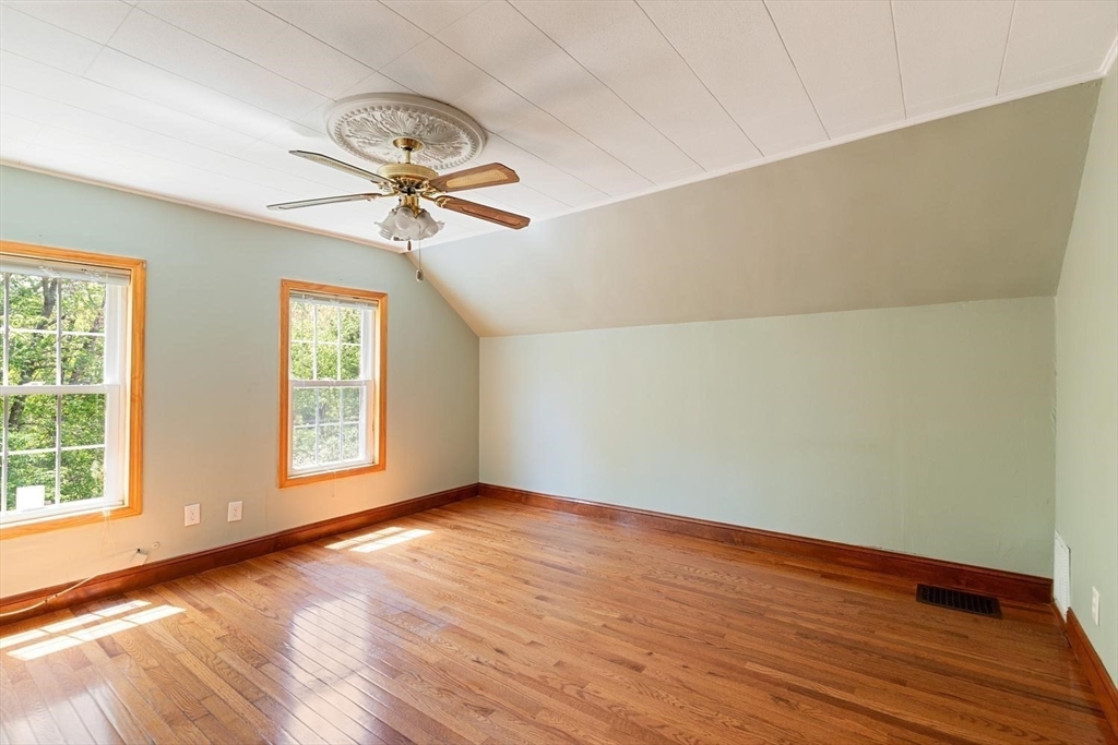 19 Butler Avenue Wakefield, MA 01880 - Photo 21 of 33 an empty room with wooden floor chandelier fan and windows