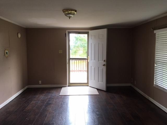 8314 Coppock Road Corryton, TN 37721 - Photo 18 of 29 an empty room with wooden floor and windows with curtains view
