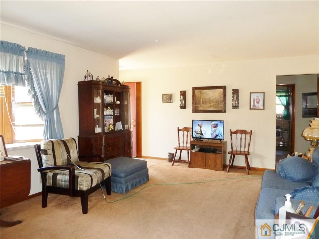 221 Crowells Road Edison, NJ 08817 - Photo 8 of 13 a living room with furniture and a flat screen tv