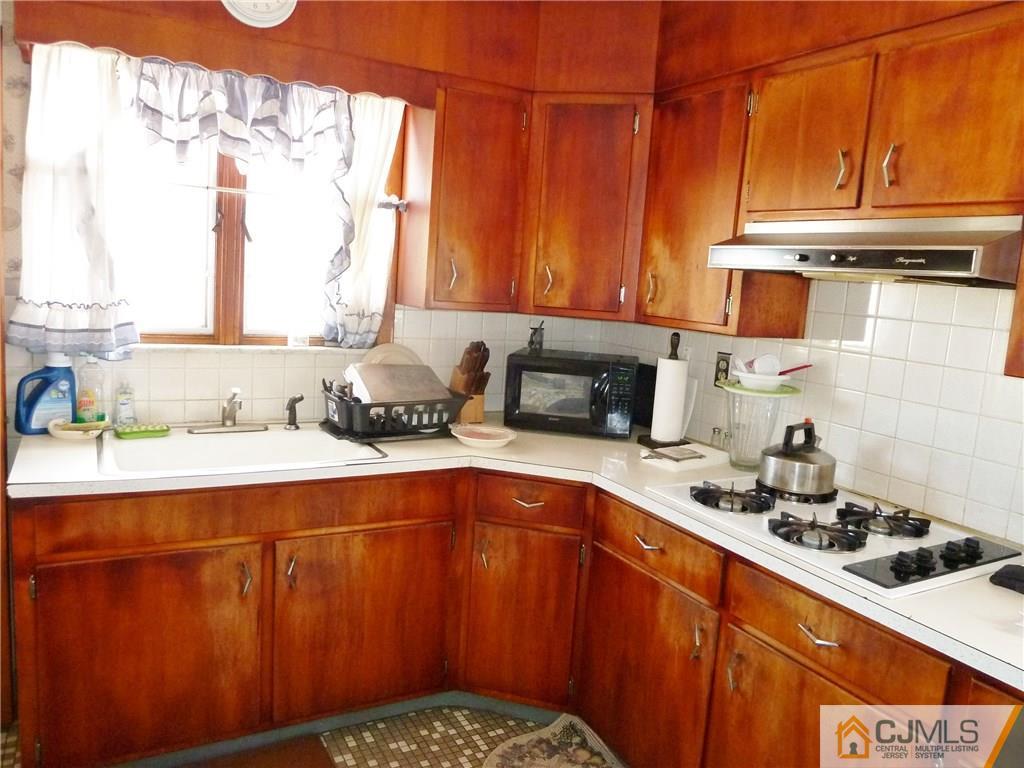 221 Crowells Road Edison, NJ 08817 - Photo 10 of 13 a kitchen with stainless steel appliances a sink a stove and a microwave