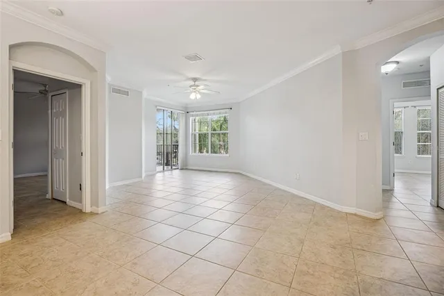 an empty room with entrance and windows