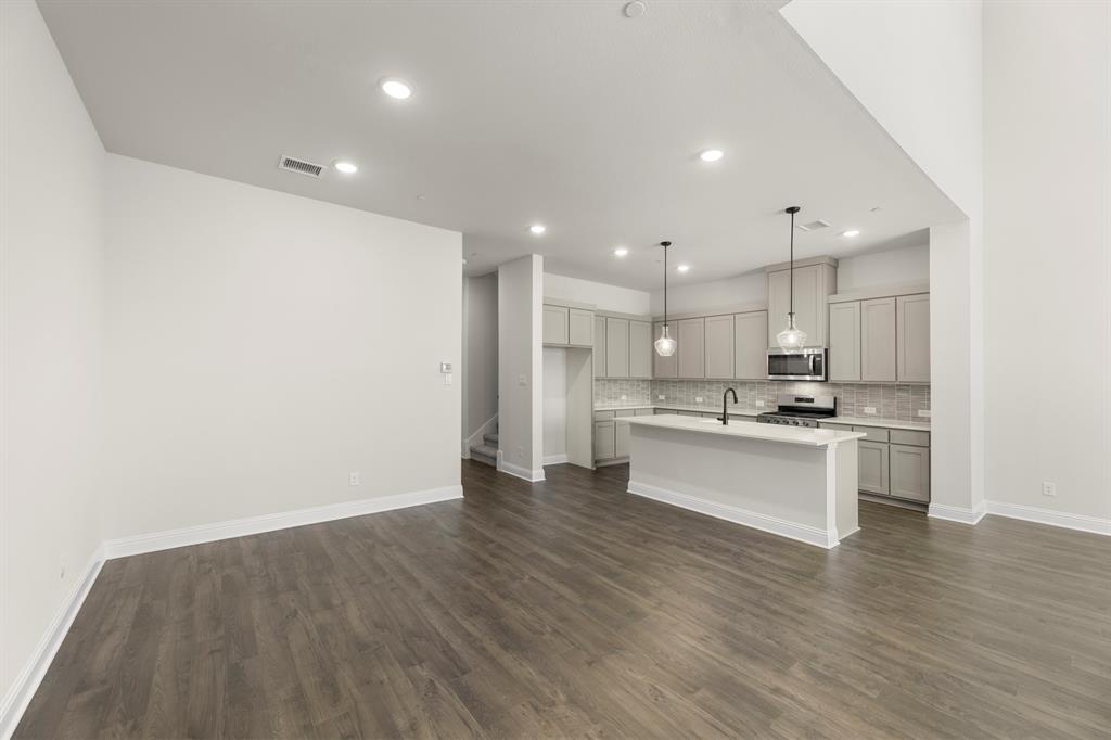 3916 Keya Drive Prosper, TX 75078 - Photo 7 of 28 a large kitchen with white cabinets and wooden floor