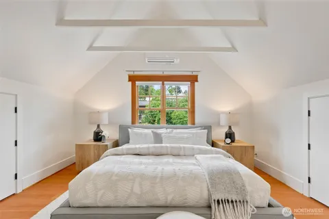 a bedroom with a bed and a window