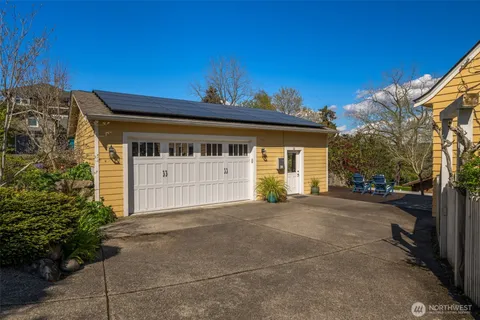 a view of a house with backyard sitting area and garden