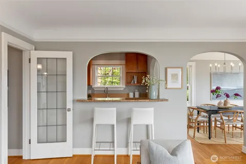 a large kitchen with stainless steel appliances granite countertop a stove a sink dishwasher and cabinets with wooden floor