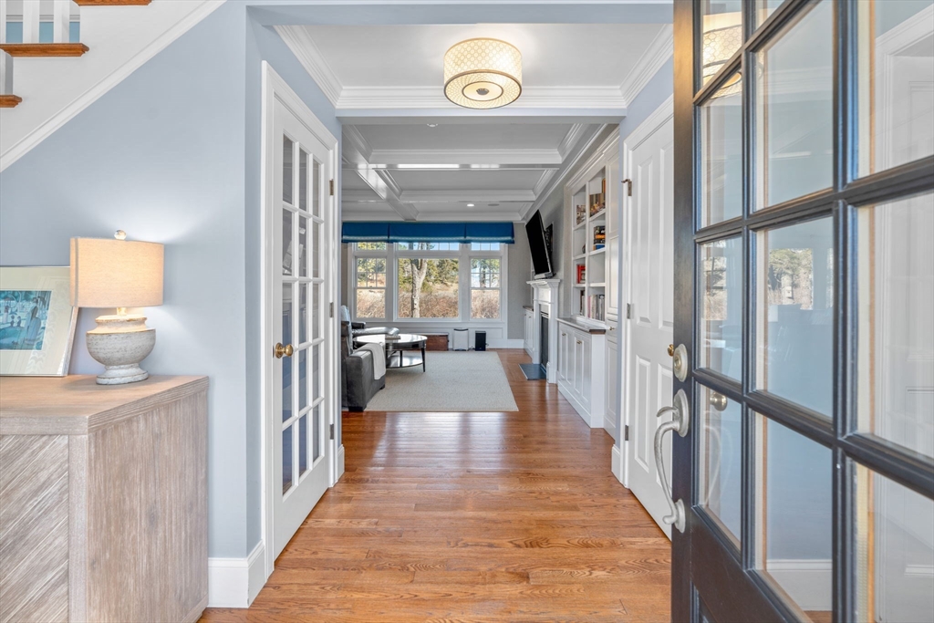67 Uncle Alberts Drive Chatham, MA 02633 - Photo 17 of 41 a view of a hallway to a livingroom with wooden floor and furniture