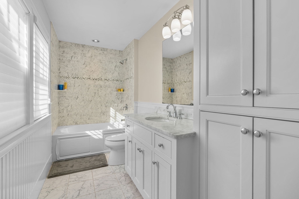 67 Uncle Alberts Drive Chatham, MA 02633 - Photo 33 of 41 a bathroom with a double vanity sink a toilet and a shower