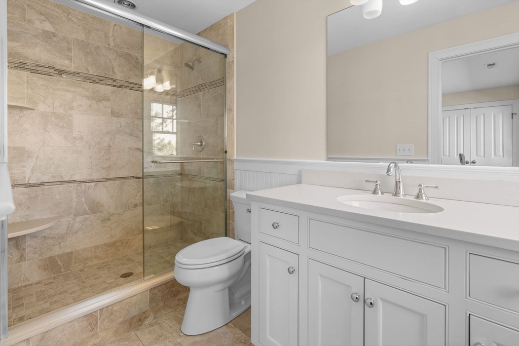 67 Uncle Alberts Drive Chatham, MA 02633 - Photo 35 of 41 a bathroom with a sink toilet a mirror and shower