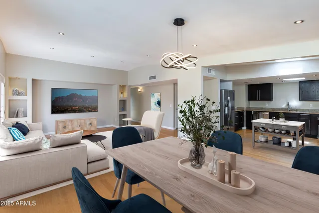 a view of a dining room with furniture wooden floor and chandelier