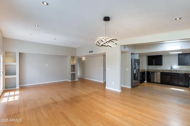 a view of a kitchen with a sink and a refrigerator