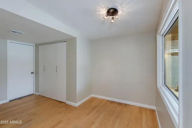 a view of a room with a window and a ceiling fan
