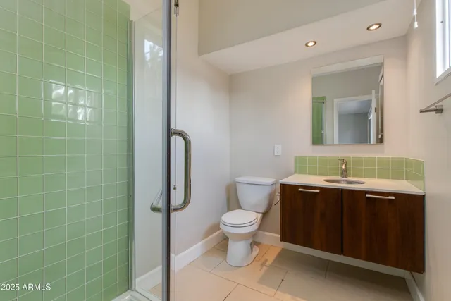 a view of bathroom with a toilet sink and mirror